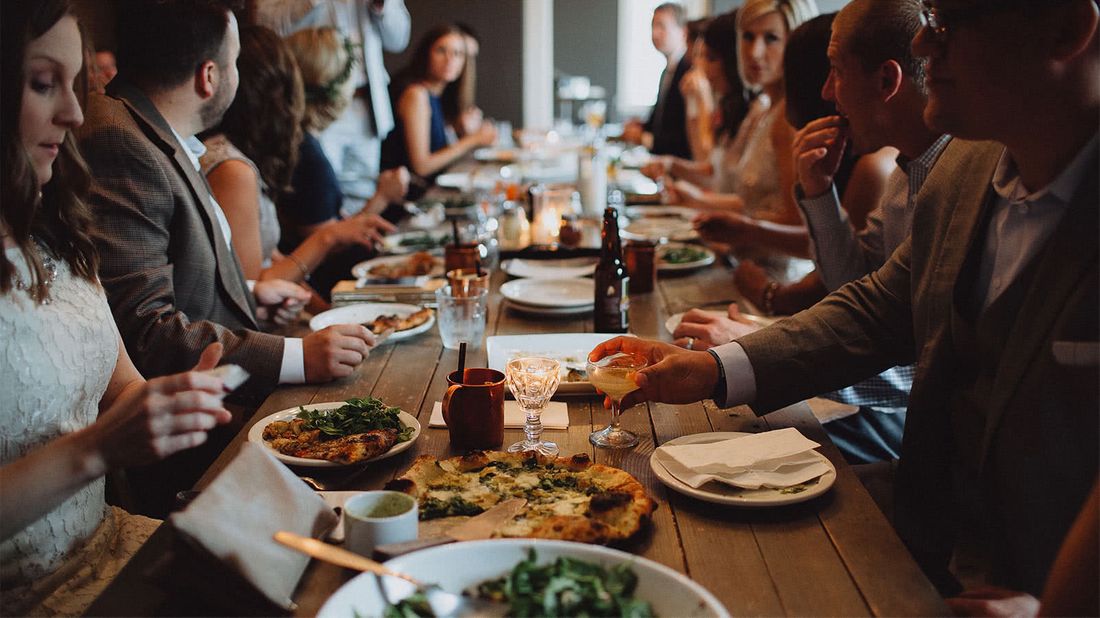 Group of friends at restaurant splitting the dinner bill