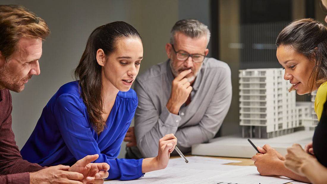 Workers discussing how men can support women in the workplace