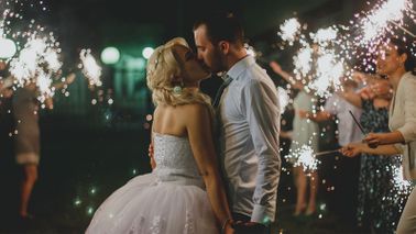 Couple kissing wondering how much does a wedding cost