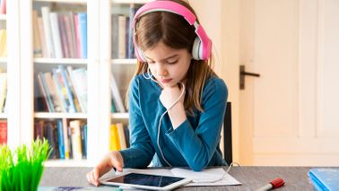 Young girl doing online learning through educational websites and apps for kids