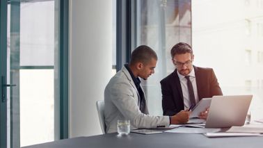 Two men discussing how to find the right financial advisor