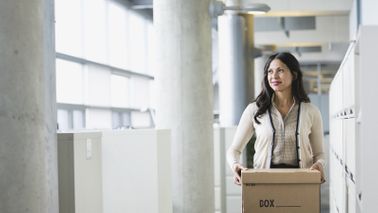 Woman leaving office after losing her job.