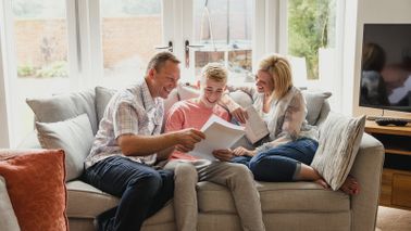 Family sitting on a coach reviewing steps to take before your child turns 18.