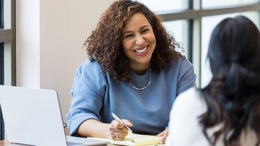 Two people meet for a job interview.