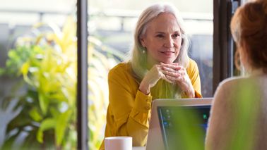 Woman discussing divorce with her financial advisor. 