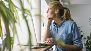 Woman thinking about what she read in Northwestern Mutual’s Weekly Market Commentary.