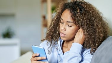 Woman reading about bear markets on her phone