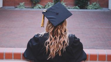 graduate reflecting on campus