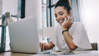Woman reading Northwestern Mutual Market Commentary on her computer