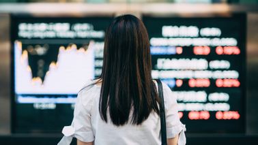 A woman looking at stock prices 