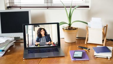 Laptop screen image of woman on video conference call 