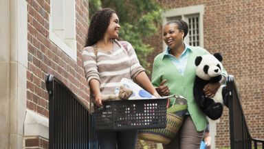 mom helping daughter move into dorm