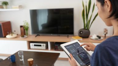 Woman using smart home products.