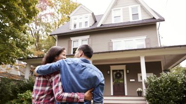 Couple looking at a house.