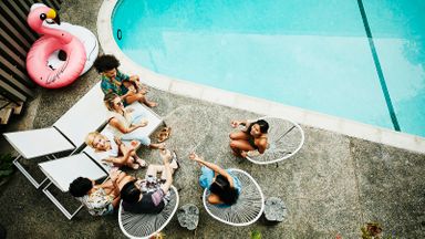 friends and family at a pool party in the backyard 