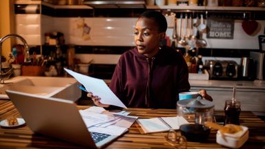 woman in kitchen considering an IRA rollover