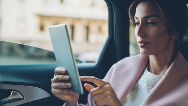 woman-checking-ira-contribution-on-tablet