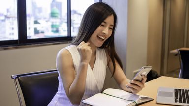 happy woman in office receiving bonus