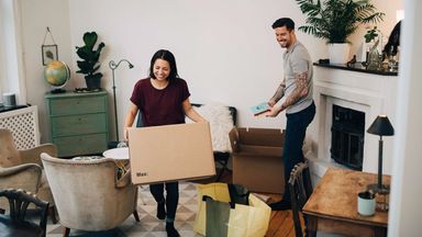couple unpacking boxes in apartment