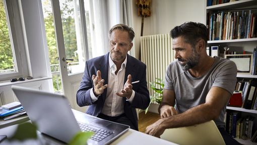 A financial advisor discusses a plan with his client